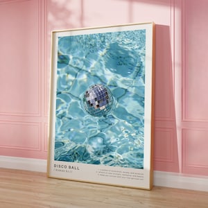 May include: A silver disco ball floating in a blue swimming pool. The text "DISCO BALL /diskan bo:1/" is below the image. The text continues: "A symbol of celebration, excess, and optimism. 1. helps you connect with your true spiritual self. 2. helps you connect with your true spiritual self. 3. helps you connect with your true spiritual self."