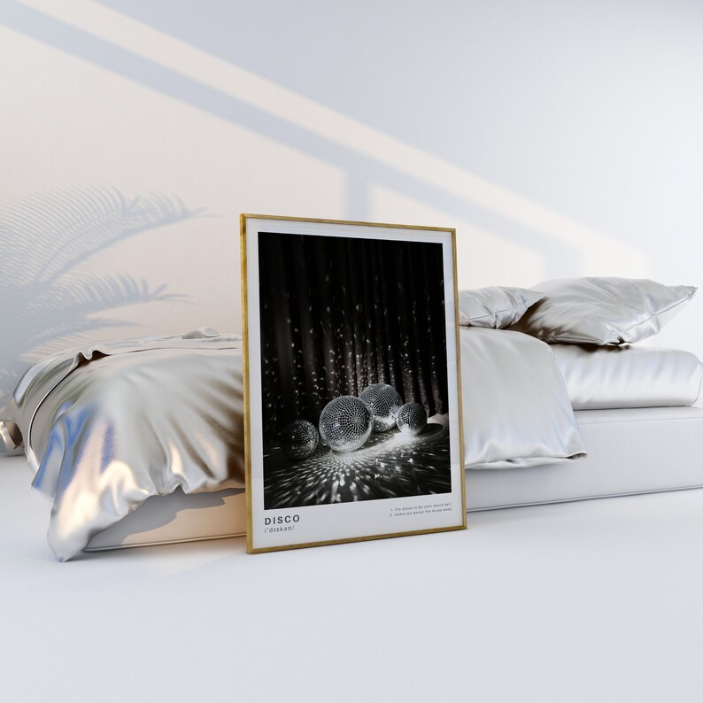 May include: A framed black and white photograph of disco balls reflecting light. The frame is gold and the text "DISCO" is printed below the image.