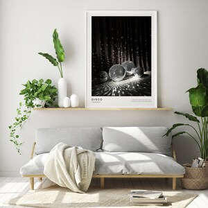 May include: A framed black and white photograph of a disco ball with the word "DISCO" printed below the image.
