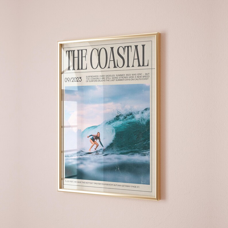 May include: Framed print titled "THE COASTAL" with a gold frame. The image features a surfer riding a large wave. The text "09/2023" is visible, along with additional text about surfing. The overall theme is surfing and coastal lifestyle.