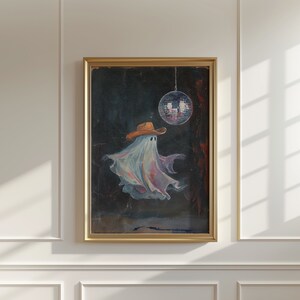May include: A framed painting of a ghost wearing a cowboy hat and dancing under a disco ball. The ghost is white and translucent, and the disco ball is silver and mirrored. The background is dark and textured.