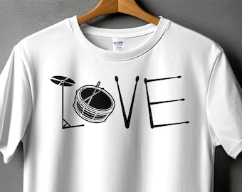 May include: White t-shirt with a black graphic of a drum set forming the word "LOVE".