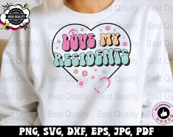 May include: White sweatshirt with a pink and blue heart design that says "LOVE MY RESIDENTS" in a retro font. The heart is surrounded by small pink and blue flowers. A stethoscope is below the heart.
