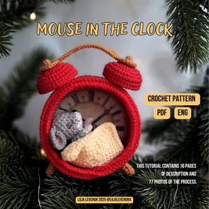 May include: A crocheted red alarm clock with a sleeping gray mouse and a yellow blanket inside. The clock has a brown handle and the text "MOUSE IN THE CLOCK". The image also includes text that says "CROCHET PATTERN PDF ENG".