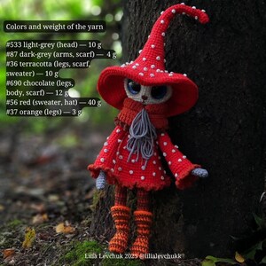 May include: A handmade crochet doll in a red mushroom outfit with white spots, a matching hat, and orange boots. The doll has light grey, dark grey, terracotta, chocolate, and orange yarn details. The doll is standing next to a tree.