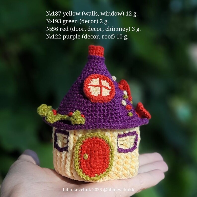 May include: A handmade crochet house with a yellow base, purple roof, and red door. The whimsical design includes a chimney and decorative elements. The house is approximately 12 grams.