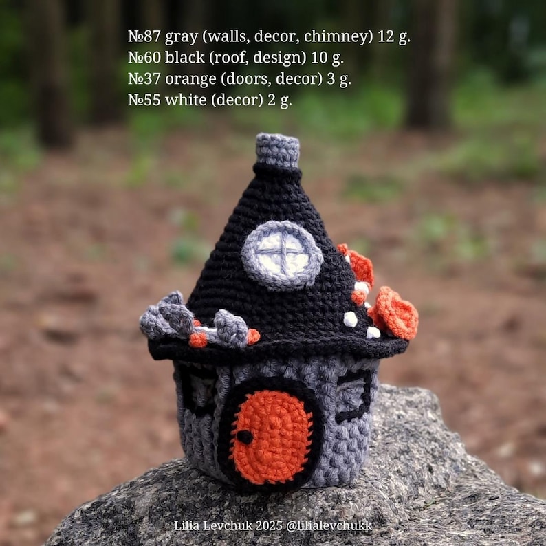 May include: A handcrafted crochet house in gray, black, and orange. The house features a black roof, an orange door, and a small round window. The text on the image reads: "№87 gray (walls, decor, chimney) 12 g. №60 black (roof, design) 10 g. №37 orange (doors, decor) 3 g. №55 white (decor) 2 g."