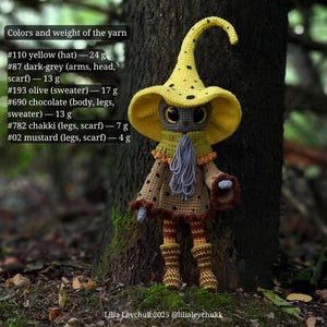 May include: A handmade crochet doll with a yellow hat and a brown sweater. The doll has a gray face and large eyes. The text on the image indicates the colors and weight of the yarn used to make the doll.