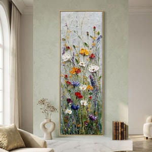 May include: A vertical framed painting of a wildflower meadow. The artwork features a textured, impasto style with colorful flowers in shades of red, yellow, white, blue, and purple against a light gray background. The frame is gold.