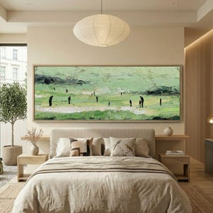 May include: A large rectangular painting depicts a golf course scene with figures in black. The artwork features a textured, green and white color palette, with a light brown wooden frame. The painting hangs above a bed with neutral-toned bedding.