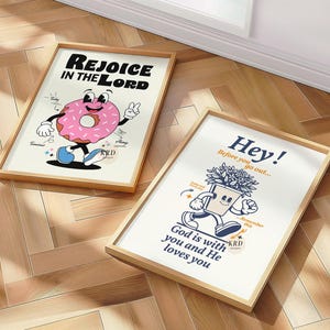 May include: Two framed illustrations with a religious theme. The first illustration features a pink and white doughnut with a smiling face and the text "Rejoice in the Lord". The second illustration features a potted plant with a smiling face and the text "Hey! Before you go out... God is with you and He loves you".