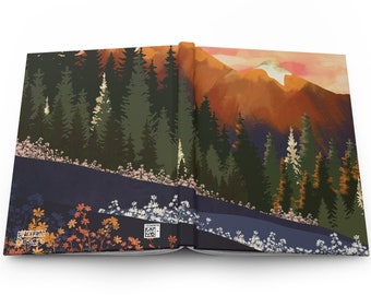 May include: An open book with a colorful illustration of a mountain range with a sunset sky and a forest in the foreground. The book has a dark blue cover with a white border.