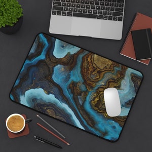 May include: A blue and gold abstract marble design mousepad with a white computer mouse on top.