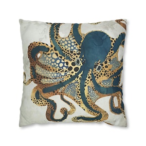 May include: A decorative throw pillow featuring a stylized octopus with blue, gold, and black patterned tentacles on a white background.