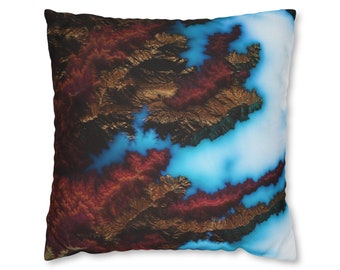 May include: A decorative throw pillow with a blue, brown, and gold abstract design. The design resembles a mountain range with a blue lake in the center.