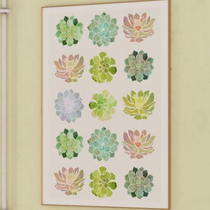 May include: A framed print with a white background featuring 16 watercolor succulent illustrations in shades of green, pink, and yellow.
