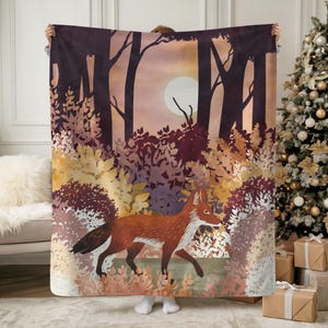 May include: A blanket featuring a forest scene with a fox. The design includes a fox walking through a forest with trees, bushes, and a full moon. The color palette includes shades of orange, brown, and purple.
