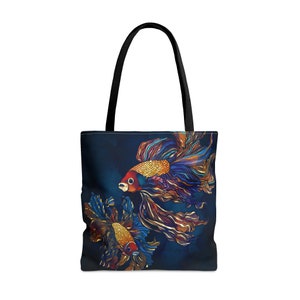 May include: A tote bag with a dark blue background featuring two colorful betta fish with flowing fins. The fish are drawn in a stylized, almost abstract way, with gold accents.