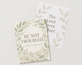 May include: A white card with a green floral border and the text "Be Not Troubled. Doctrine & Covenants 45:35". A second white card with a green floral border and the text "The Lord loves comfort" is partially visible behind the first card.