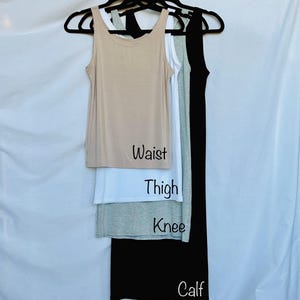 May include: Four tank tops in different lengths, from shortest to longest: beige, white, gray, and black. The lengths are labeled "Waist", "Thigh", "Knee", and "Calf".