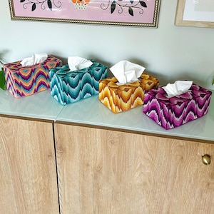 May include: A set of three ceramic mugs with a speckled, matte finish. The mugs are in shades of cream, light gray, and dark gray. Each mug has a simple, minimalist design and a rounded handle.