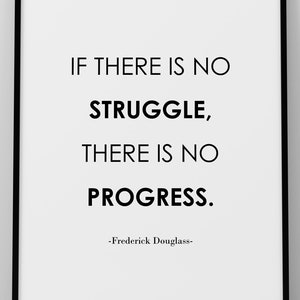 May include: A framed print with a black border and a white background. The print features the quote "IF THERE IS NO STRUGGLE, THERE IS NO PROGRESS." by Frederick Douglass in black text. The print is displayed on a white surface.