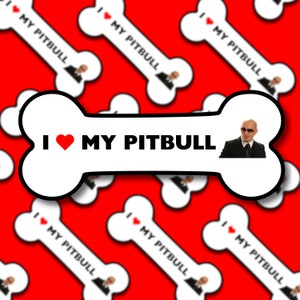 May include: White bone-shaped sticker with a red heart and the text "I ♥ MY PITBULL" in black. A cartoon image of a man with a shaved head and sunglasses is in the upper right corner of the sticker.