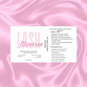 May include: Pink and white label with the text "LASH CLEANSER" in a pink script font. The label also includes the text "FOR EYELASH CLEANSING / MAKEUP REMOVER", "PH BALANCED OIL FREE", "VEGAN FRIENDLY BETTER RETENTION", "60 ML", "GLAM & GLOW STUDIO", "USE DAILY WITH CLEANSING BRUSH", "DIRECTION", "Dispense 1-2 pumps of Lash shampoo into palm of hand. Swirl foam with cleansing brush then apply to lids and gently brush through lashes. To finish, rinse lids and lashes with water. Pat dry.", "INGREDIENTS", "cabbage rose (rosa centifolia) flower water, water (aqua) louryl betaine, acrylates/beheneth-25, methacrylate copolymer, triethanolamine, phenethyl alcohol, phenoxyethanol, sodium PCA, Grape (vitis"