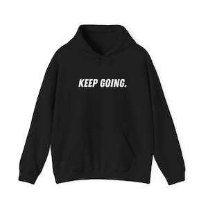 May include: Black hooded sweatshirt with the text "KEEP GOING." printed in white on the front.