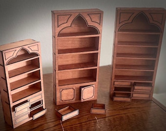 May include: Three wooden bookcases with arched tops and decorative details. The bookcases have multiple shelves and drawers. The bookcases are made of a light brown wood.
