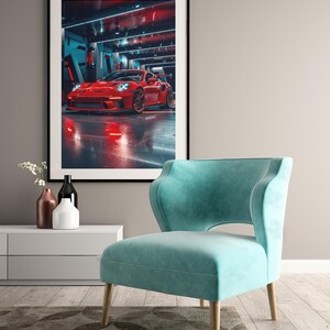 May include: A framed print of a red sports car in a futuristic garage setting. The car is the focal point, with a sleek design and glowing red lights. A teal armchair with wooden legs sits in front of the print, adding a pop of color.