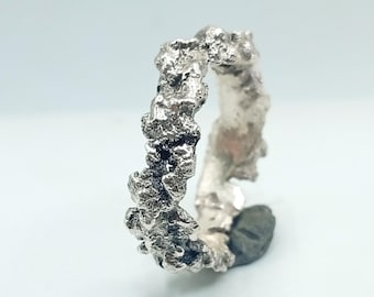 Brutalist style molten silver ring band