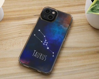 May include: A clear phone case with a galaxy-like design featuring the Taurus constellation and the word "Taurus" in white text.