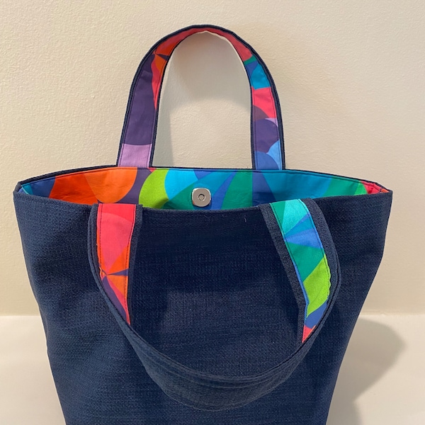 Reversible multicolored shapes and navy tote