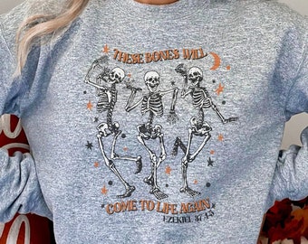 May include: Gray sweatshirt with a graphic of three skeletons dancing and the text "These bones will come to life again - Ezekiel 37:1-14".