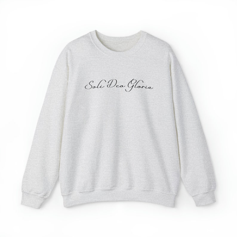 May include: A heather grey sweatshirt with the text "Soli Deo Gloria" printed in black on the front.