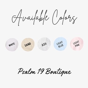 May include: Image displaying the text "Available Colors" in a script font, with five color swatches below: white, sand, ash, light blue, and light pink. The text "Psalm 19 Boutique" is written below the color swatches.
