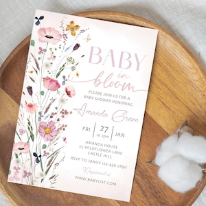 May include: A baby shower invitation with a floral design. The invitation features the words "BABY in bloom" in pink script. The invitation also includes the name "Amanda Green" and event details.