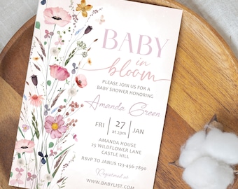 May include: A baby shower invitation with a floral design. The invitation features the words "BABY in bloom" in pink script. The invitation also includes the name "Amanda Green" and event details.