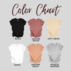 May include: Color chart showing six different t-shirt colors: black, heather mauve, soft cream, white, heather peach, and athletic heather.