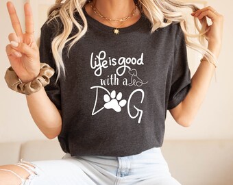 May include: A dark gray t-shirt with a white graphic that says "Life is good with a DOG" and features a paw print and a small dog illustration.
