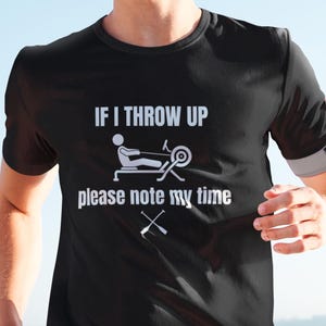 May include: A black t-shirt with a white graphic that says "If I throw up please note my time" with a rowing machine and oars.