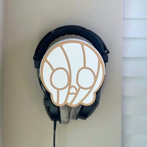 Soporte para auriculares y estante de pared con forma de calavera (paquete de inicio 2 en 1) con placa frontal intercambiable