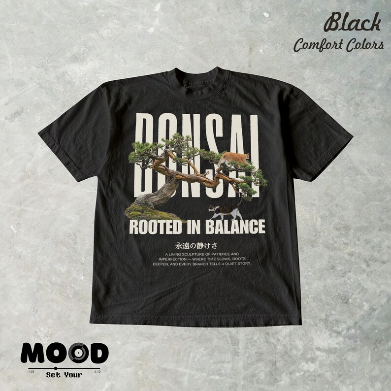 May include: Black t-shirt with a bonsai tree graphic and the text "BONSAI ROOTED IN BALANCE". The design includes a cat on the tree and Japanese text. The shirt also has the text "Black Comfort Colors" at the top.