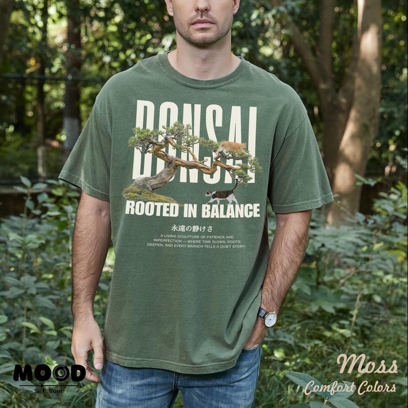 May include: Green t-shirt with a bonsai tree graphic and the text "BONSAI ROOTED IN BALANCE". The shirt also features Japanese text and the words "MOOD" and "Comfort Colors".