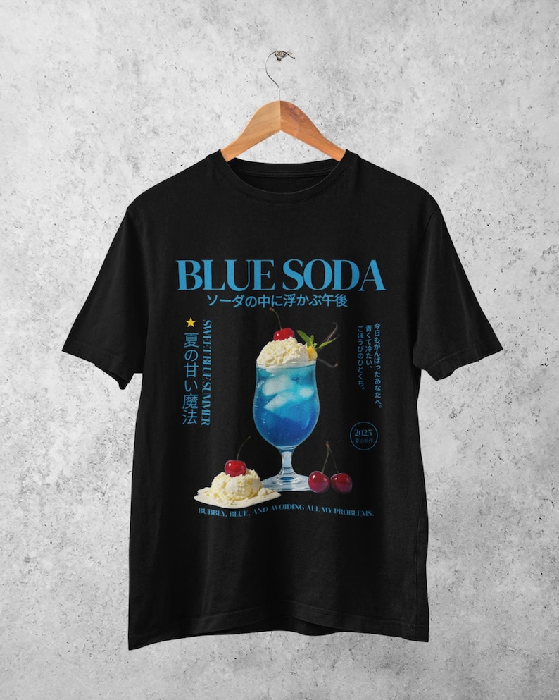 May include: Black t-shirt featuring a blue soda graphic with Japanese text. The design includes a blue cocktail with whipped cream and cherries, and the words "BLUE SODA" in large blue letters.