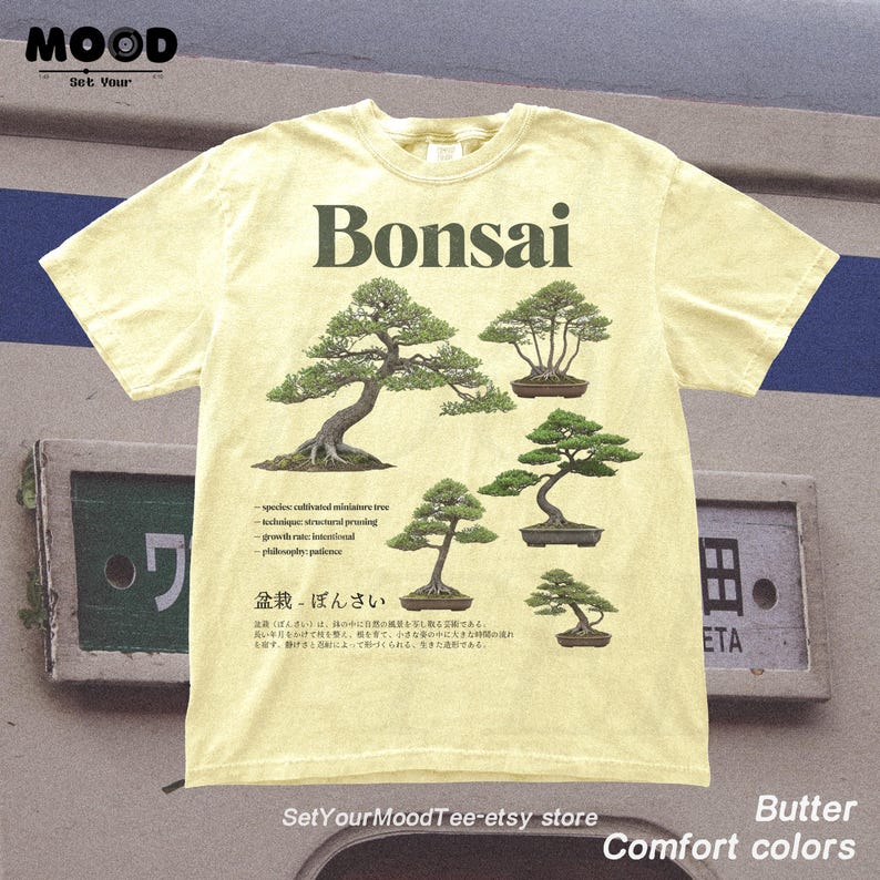 May include: Butter-colored t-shirt featuring the word "Bonsai" above illustrations of bonsai trees. The shirt includes text about bonsai cultivation and the Etsy store name. The shirt is part of the "Comfort Colors" collection.