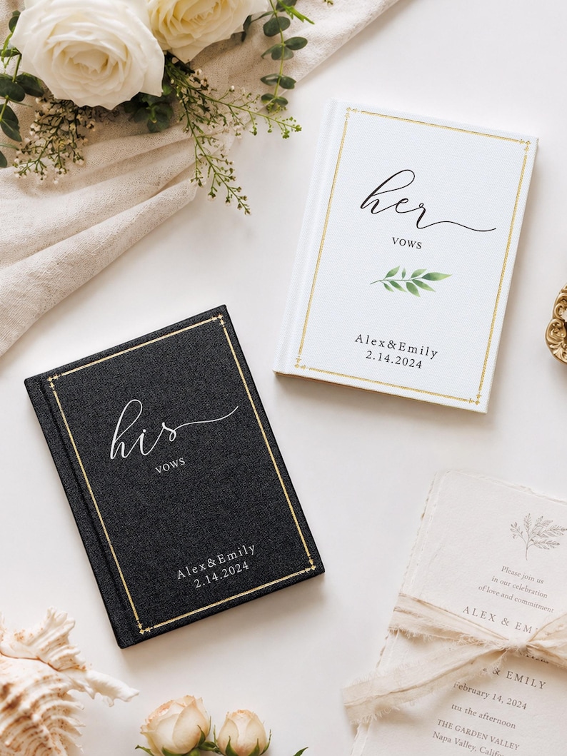 May include: Two hardcover vow books, one black and one white, featuring gold foil borders and text. The black book reads 'his vows' and the white book reads 'her vows', both personalised with 'Alex & Emily' and the date '2.14.2024' in black ink.