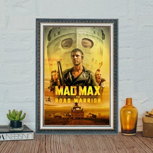 May include: A framed movie poster for the film "Mad Max: The Road Warrior". The poster features a yellow and orange color scheme with a close-up of Mel Gibson as Max Rockatansky, wearing a leather jacket and holding a shotgun. The poster also features a large, menacing, masked figure in the background.