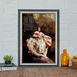 May include: A framed movie poster for the film "Poor Things" starring Emma Stone, Mark Ruffalo, Willem Dafoe, Ramy Youssef, and Jerrod Carmichael. The poster features a woman in a pink dress with a white collar.